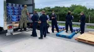 Exchange team unloads pallet of water