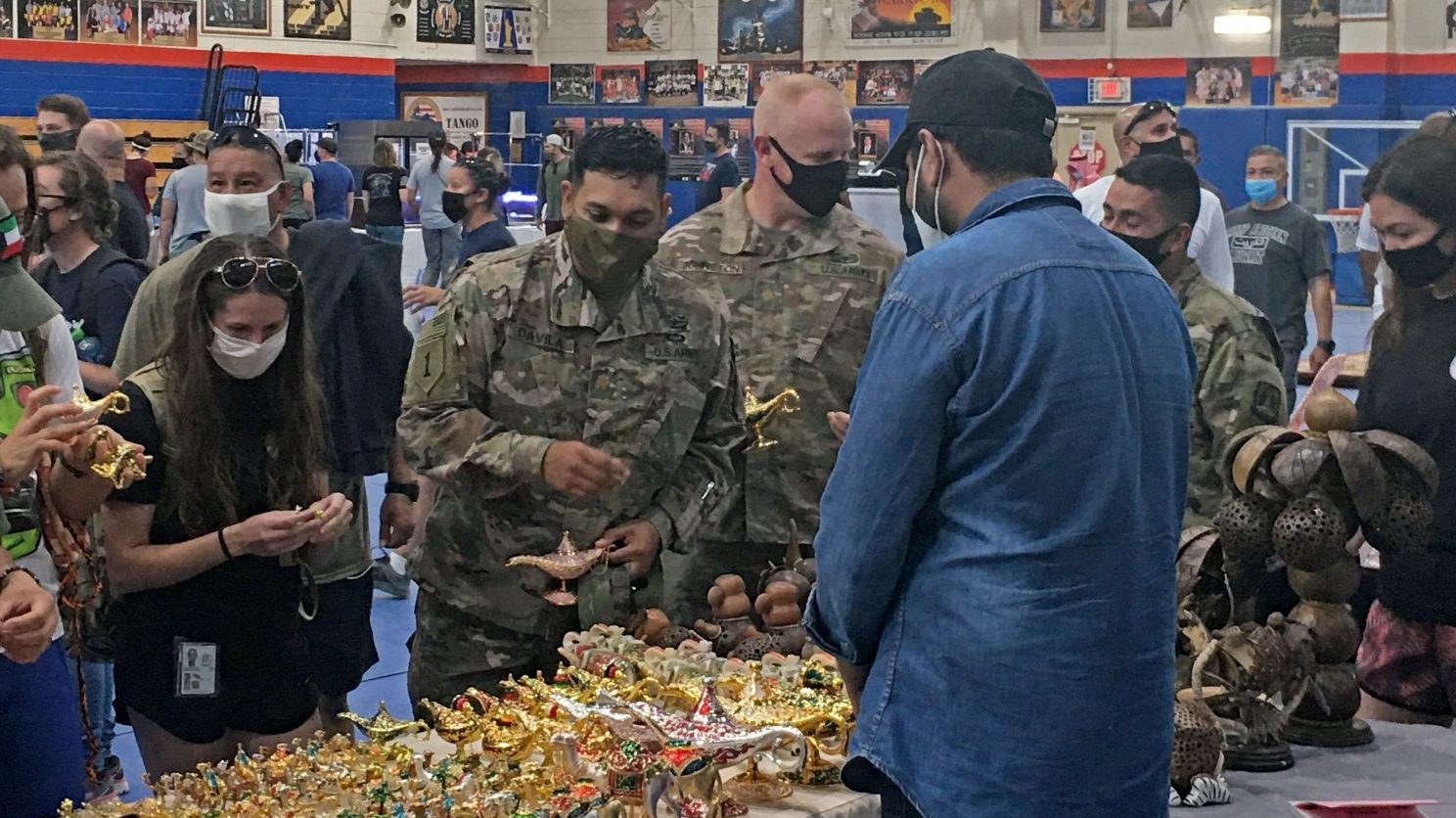 Service members peruse the wares of local vendors recently during a holiday shopping bazaar at Camp Arifjan in Kuwait.