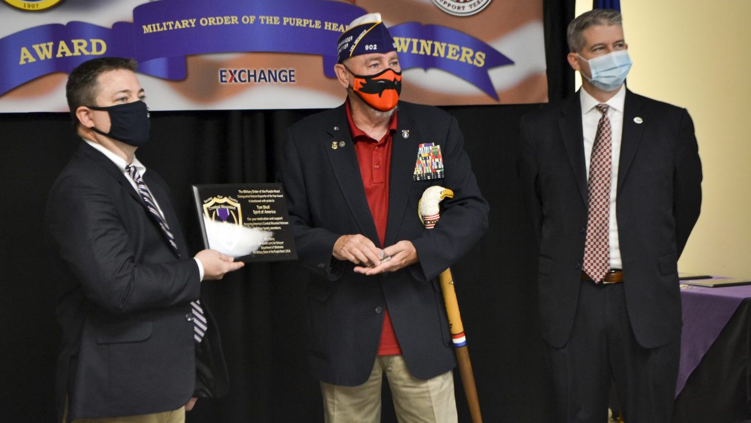 Retired Navy Master Chief Larry Van Schuyver, Military Order of the Purple Heart representative and chairman of the Oklahoma Veterans Commission (middle), presents Tinker AFB Exchange General Manager Charles Eaves with the Military Order of the Purple Heart’s Business Supporter of the Year award Nov. 10 at the Tinker AFB Exchange.