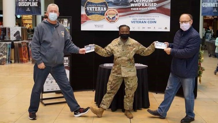 Sgt. Maj. Julia Henry (center), senior enlisted advisor of the Exchange’s Europe/SW Asia Region, hands out challenge coins to Air Force Veterans Master Sgt. (retired) Richard Rhodes (left), and Senior Master Sgt. George Labbay (right) in honor of Veterans Day at the Kaiserslautern Military Community Center Exchange in Germany Nov. 11. (courtesy photo)