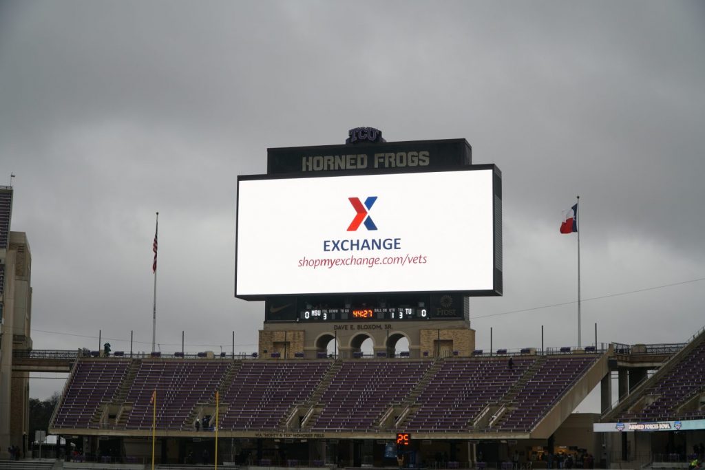 Jumbo scoreboard with the Exchange logo inside TCU's football stadium.