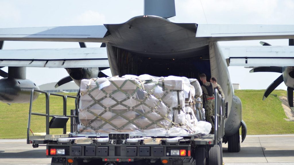 Airmen assigned to 733rd Air Mobility Squadron loads nearly 3,100 Burger King buns onto a C-130 provided by the Marines Corps Air Station, in Iwakuni, Japan on Kadena Air Base, Okinawa headed to Andersen Air Force Base, Guam. In a joint effort, Airmen and Marines saved the Exchange an estimated $46,000 in combined commercial flight delivery costs and potential lost in sales from Burger King’s most popular sandwiches.  All of savings and sales translates into dividend contributions directly supporting quality of life and family support programs. (U.S. Army Photo by Staff Sgt. Mark A. Kauffman)