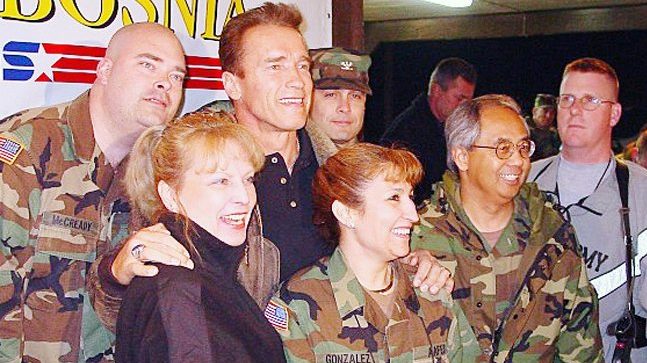 <b>Darrin McCready, at left, and other associates pose with Arnold Schwarzenegger after a screening of Schwarzenegger's movie "Collateral Damager" in 2002 in Bosnia.