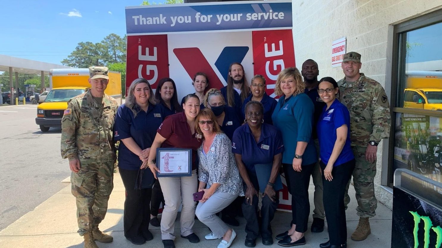 Fort Bragg Garrison Commander Col. Scott Pence, left, with Old Glory Express team members Carmen Griffin, Allison Lincourt, Angel Michael, Tina Hulin, Alex Dewberry, Wanda Sumner, Ryan Dickinson, Sandra Lambert, Zsa Zsa la Moore, Amanda Hartfield, Daymond Moultrie, Madeline Salazar, and Command Sgt. Maj. Jeffrey A. Loehr.