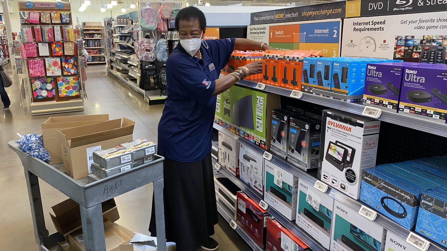 <strong>Rozsele Catanch, known as "Ms. Sue," stocks shelves at the Shaw Air Force Base Exchange. She is known for her intercom announcements and for promoting store events on Facebook Live, where she might even sing a song.</strong>