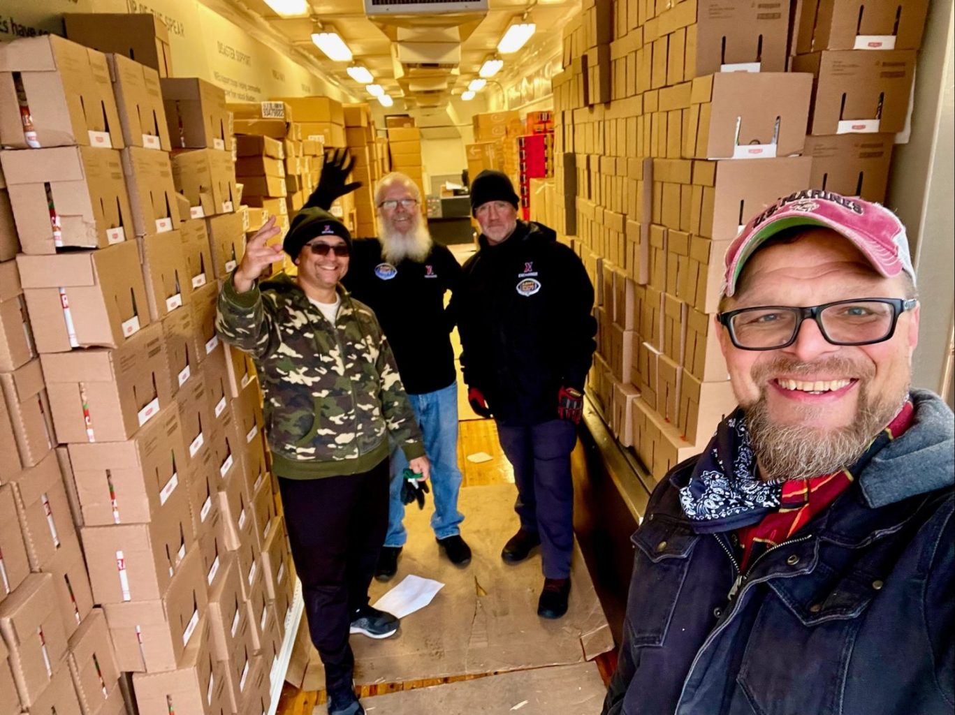 <strong>From left: Exchange truck drivers Eddie Hill and Bradley Wacks, Military and Veteran Outreach Manager Brian Schooley and Creative Director Johnny Olson get snacks ready fr the bonfire before the Army-Navy game.</strong>