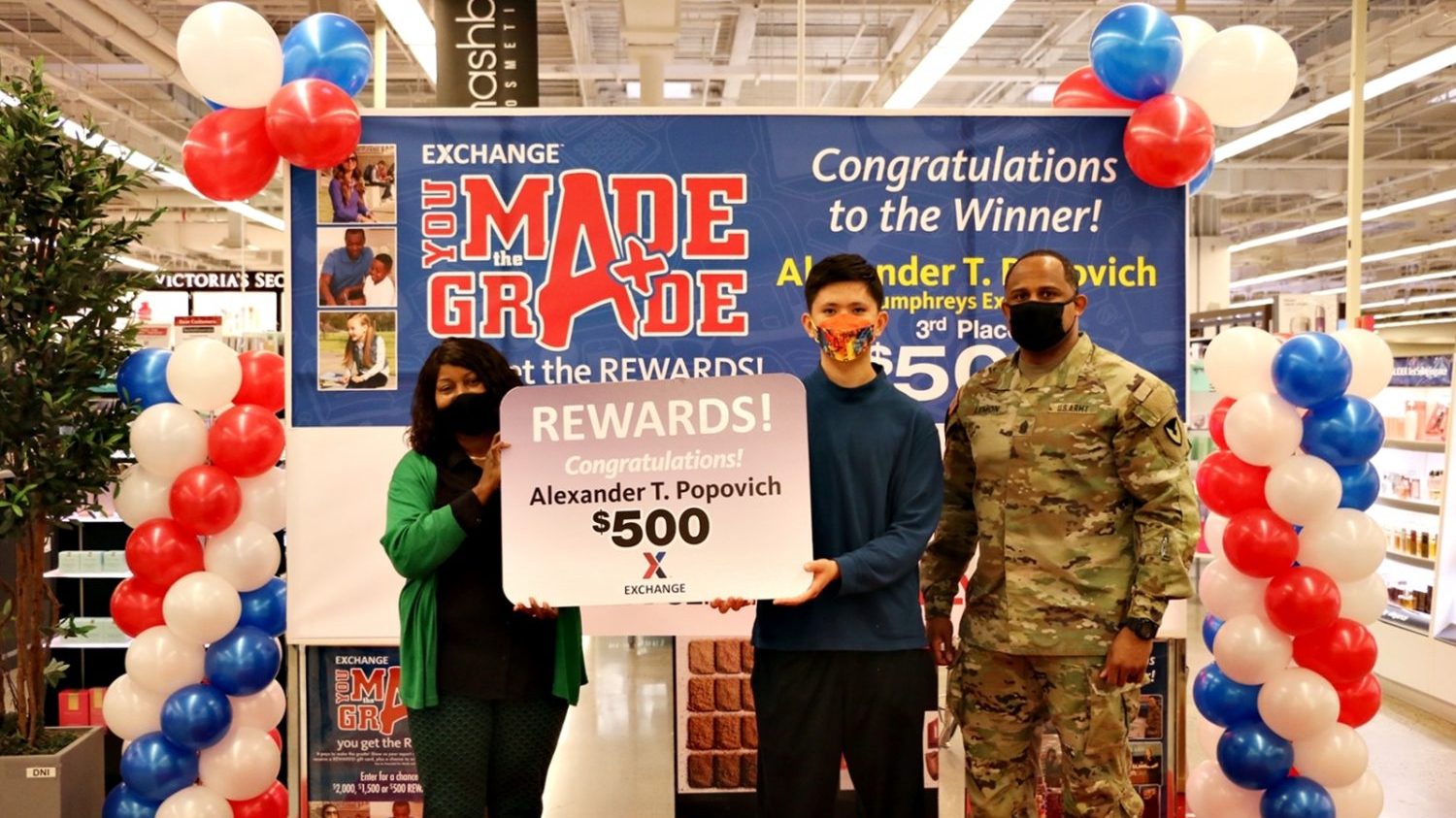 Humphreys Exchange’s General Manager Vanessa Rowland and United States Army Garrison Command Sgt. Maj. Benjamin Lemon Jr., garrison’s senior enlisted leader, pose for a picture with Alexander Popovich, a 9th grader at Camp Humphreys High School who won $500 for winning 3rd place in the Exchange’s You Made the Grade sweepstakes. The Exchange has been rewarding students with a $5 Exchange gift card for maintaining at least a B average, each quarter, for the past 22 years with a chance to win $2000, $1500 and $500 in a worldwide sweepstakes in December and June. (Exchange Photo by Mun, Yong-chin)