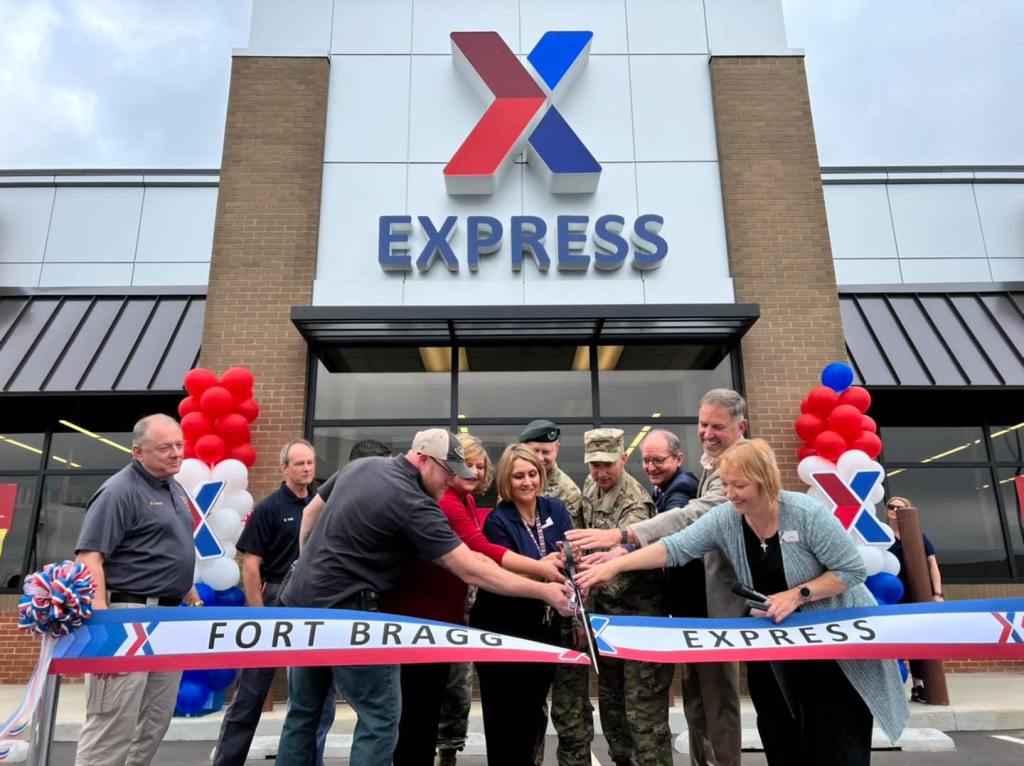 <b>From left, Chris Snyder, quality assurance specialist with Fort Bragg Network Enterprise Center; Amanda Hartfield, Fort Bragg Exchange General Manager; Maureen Coleman, Yarborough Express store manager; Brig. Gen. Derek Lipson, 1st Special Forces Command (Airborne) deputy commanding general; Col. Scott Pence, garrison commander; Richard Holcomb, retired deputy to the commanding general for the U.S. Army Special Operations Command; Mike Smietana, Exchange senior vice president of Real Estate; and Natalia Meyer, Exchange retail business manager; cut the ribbon on the new Yarborough Express on May 24. (U.S. Army Photo by Jacqueline Hill, Fort Bragg Public Affairs Office)