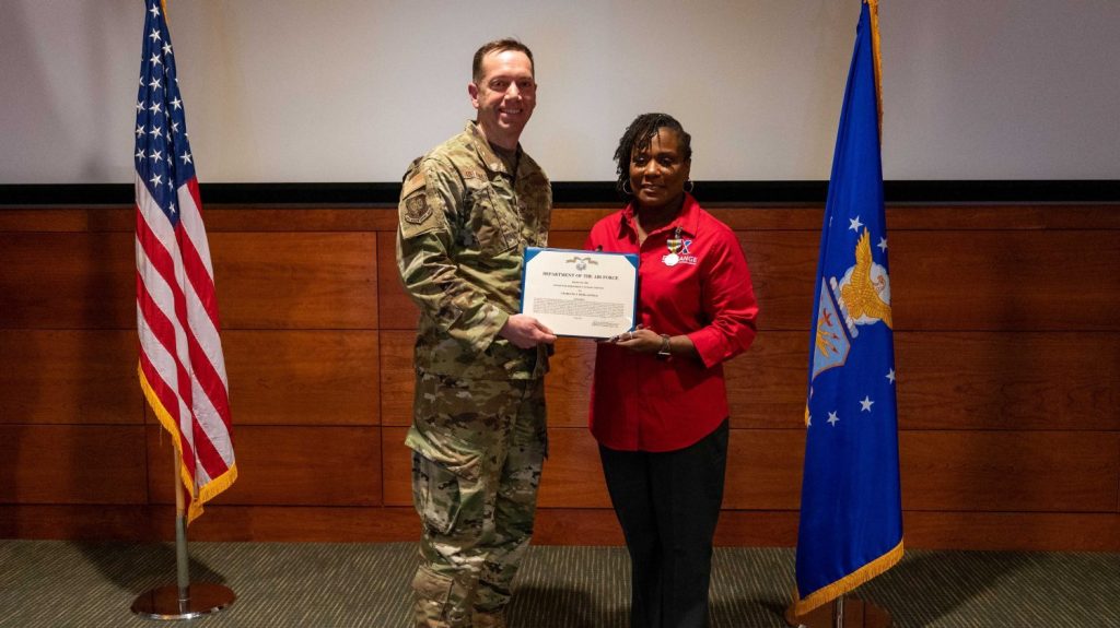 <strong>Col. Jason Delamater , 673rd Force Support Squadron Commander, presents Joint Base Elmendorf-Richardson General Manager CJ Morganfield with the Air Force Meritorious Civilian Award for her work in supporting the JBER community.</strong>