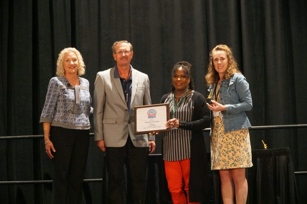 <strong>C.J. Morganfield, Joint Base Elmendorf-Richardson general  manager, accepts the award for the Western Region Rock Your Sales award for the Richardson Troop Store. Also pictured are Consumables Vice President Martha Robuck; Divisional Merchandise Manager David Arens; and Divisional Merchandise Manager Danielle Pelland. </strong>