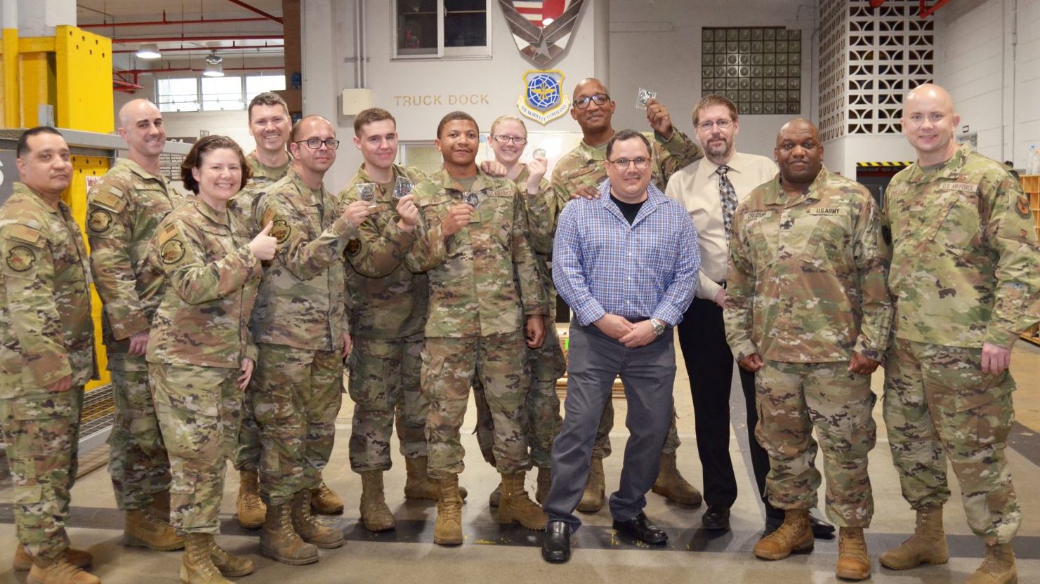 <b>The Exchange AAFES Pacific Region team, Col. Michael Kovalchek, commander, and Sgt. Maj. Wayne Crudup, senior enlisted leader, thanked and gave their “Coin of Excellence” and a Free Combo Meal ticket to Staff Sgt. Robert Williams, Senior Airmen Matthew Turner and Ashley Spoon-Roth, Airmen First Class Robert Berry and Eric Stoltz from 733rd Air Mobility Squadron for their helpful contributions during “Operation Okidough” by receiving more than 13,800 bakery products from Yokota AB while the main oven from the bakery on Camp Kinser was inoperable. Okinawa General Manager David Swenson and Distribution Center Manager Lewis Meza attended the coining to personally thank them for their help so 32 facilities to include the School Meal Program on Okinawa could operate as normal. (U.S. Army Photo by Staff Sgt. Mark A. Kauffman)</b>