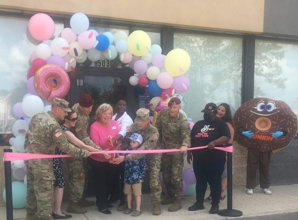 <b>Commanding General Brigadier Gen. David Gardner and his wife, Renee, Garrison Commander Col. Stephen Smith, Command Sgt. Maj. Stephen Neilson, Command Sgt. Maj. David Hanson and his wife Christina and son Colt, and Logan Morris of the Greater Vernon Chamber of Commerce helped Exchange leaders cut the ribbon on the new offering. Note the Dunkin' mascot at right.</b>