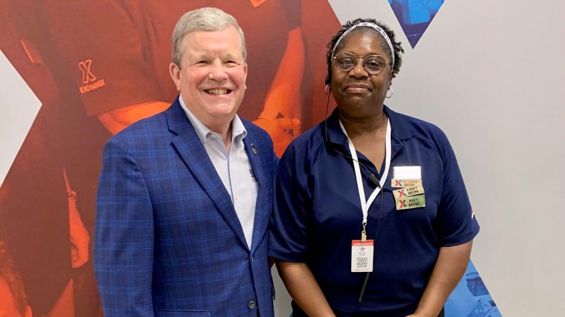 <b>Deborah Williams, sales & merchandise manager at JBSA-Fort Sam Houston, with Exchange Director/CEO Tom Shull. Note Williams three "Badges of Honor" telling shoppers and teammates about her being a mother to children who either are serving or have served in three branches of the military.</b>