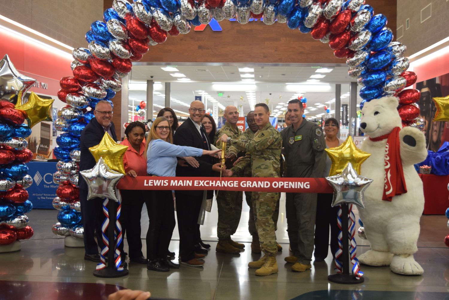 <b>From left, Exchange Western Region Senior Vice President Ronny Rexrode, JBLM Lewis Exchange Food Business Manager Patricia Beavers, JBLM Lewis Exchange Main Store Manager Stacie Sterling, JBLM Exchange General Manager Matthew Beatty, Command Sgt. Maj. Waylon Perry, Col. Christopher Hall, Garrison Commander Col. Phil Lamb, Vice Wing Commander Col. David J. Morales; in back, Food Business Manager Kathleen Phelps, Exchange Northwest Area Regional Vice President Carrie Cammel, Chief Master Sgt. John Marquez and JBLM Lewis Exchange Retail Business Manager Penny Palmer cut the ribbon on the Joint Base Lewis-McChord Lewis Main Exchange’s $72.6 million renovation Sept. 28. Photo by JBLM Lewis Exchange Sales and Merchandise Manager Jocelyn Rosario.

