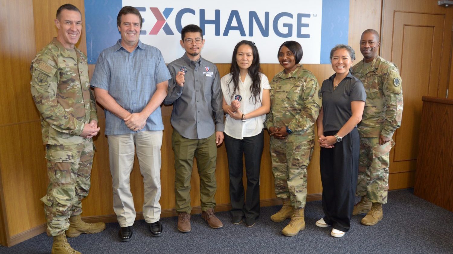 <b>From left: Pacific Region Headquarters Commander Col. Jason L. Beck, IT Field Tech Supervisor Chris Vaughan, IT Specialist Tetsu Sakihama, IT Specialist Mika Belote, PAC Region Senior Enlisted Advisor Generose Green, IT Pacific Field Support Manager Shinobu Agarie and Deputy Commander Lt. Col. Lanelle Pickett Jr. pose for a picture after Beck and Green awarded Sakihama and Belote with their Coin of Excellence for their selfless service. They were called to duty to fix Camp Foster Burger King menu board that took several hours of communication and troubleshooting while working with LSI Corporation located in the U.S. (U.S. Army Photo by Staff Sgt. Mark A. Kauffman)