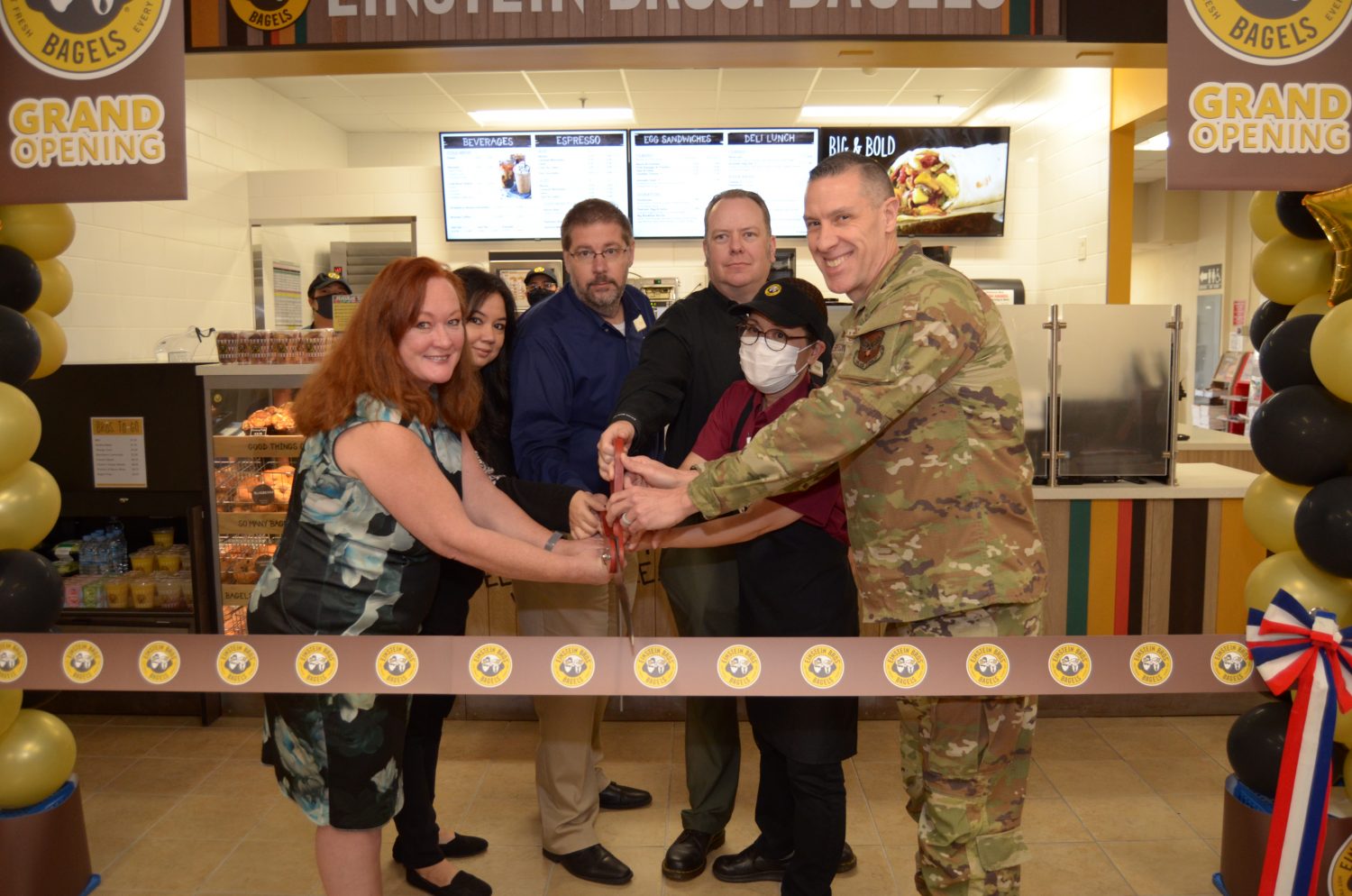 <b>From left: Dr. Jolene Cantrell, deputy Director of Installation Support; Marnya Berry; chief facility manager of Engineering; David Swenson, Okinawa Exchange general manager; Andrew Nims, Kadena food court manager; Taeko Smith; Einstein Bros. Bagels manager; and Air Force Col. Jason L. Beck, Exchange Pacific Region commander, prepare to cut the ribbon at the grand opening of the Einstein Brothers Bagles at the Kadena Air Base Exchange. (U.S. Army Photo by Staff Sgt. Mark A. Kauffman)</b>