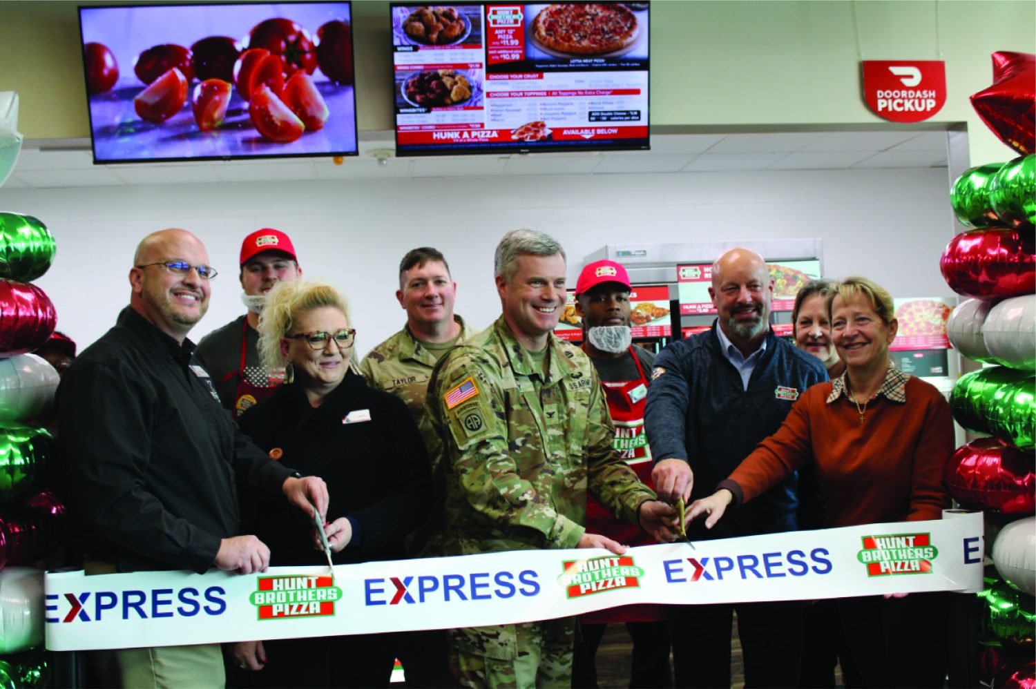 <B>Front row, from left: Fort Sill Exchange General Manager Mikel Hunter, Facility Manager Angela McCracken, Garrison Commander Col. James Peay, Hunt Brothers Pizza representative Steven Church and Garrison Deputy Commander Ms. Julia Sibilla. Back row, from left: Associate Joseph Claflin, Command Sgt. Maj. William, Associate Dante McCowan and Assistant Store Manager Bonnie Hines.
