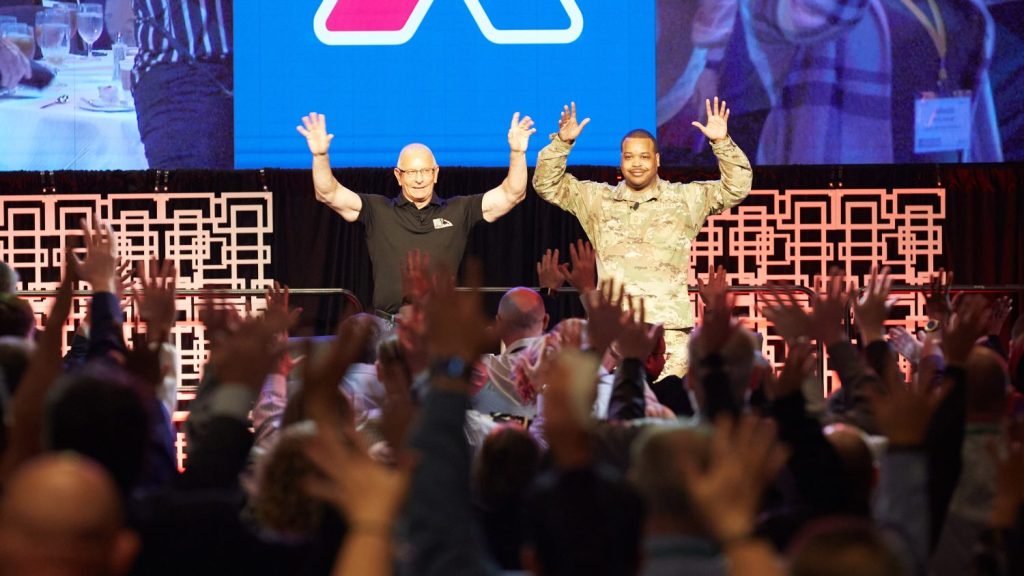 <b>Before his "Chief Chat" with Exchange Senior Enlisted Advisor Chief Master Sgt. Kevin Osby (right), celebrity chef Robert Irvine encouraged the audience to wave their hands in the air and scream.</b>