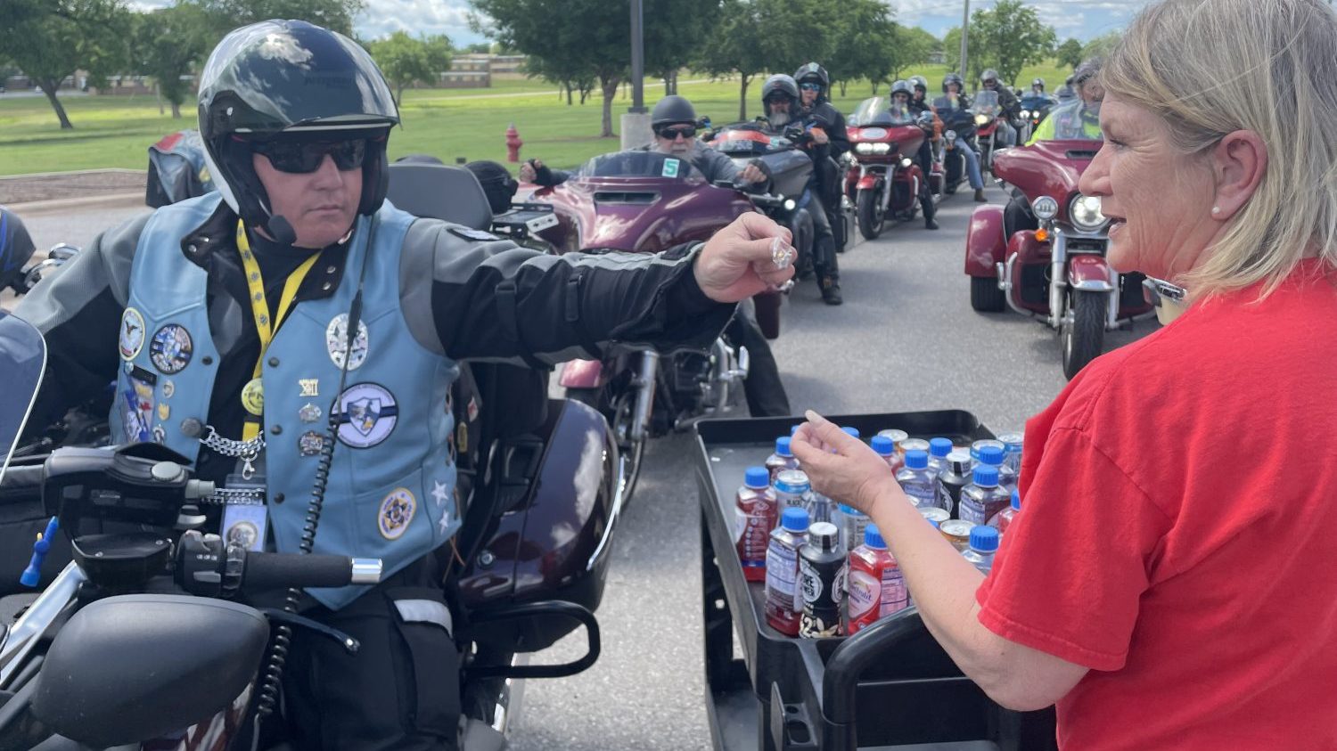 <b>Theresa Jones, Fort Sill customer experience associate, receives a special lapel pin from one of the "Run for the Wall" riders.</b>