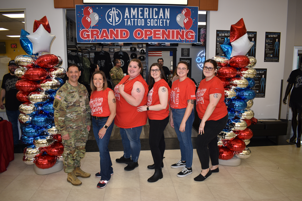 From left, Fort Drum Garrison Commander Col. James Zacchino, Fort Drum Exchange General Manager Thea Sarver, GM Administrative Assistant Liz Huntington, Services Business Manager Abigail Wilson, Services Vending Associate Megan Walter and Services Operations Assistant Lorin Puckett at the June 14, 2023, grand opening of American Tattoo Society at Fort Drum.
