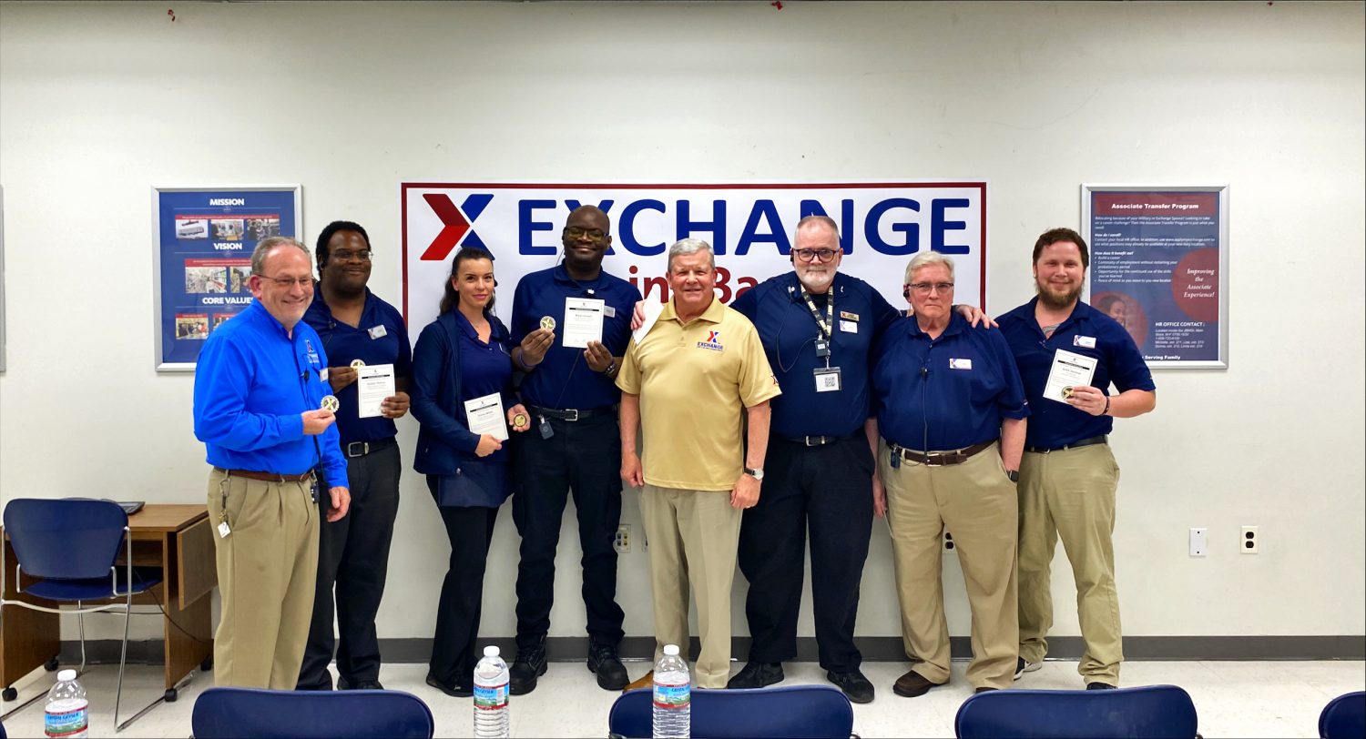 <b>Exchange Director/CEO, center, with the seven JBMDL associates he recognized for their work. From left: John Monaghan, store manager, JBMDL main store; Jocinto Thomas, customer experience associate, JBMDL main store; Stacey White, customer experience associate, JBMDL main store; Bryan Howell, customer experience associate, JBMDL main store; Mr. Shull; Brad Robinson, computer operator, JBMDL main storre; Robert “Bob” Metz, sales area manager, JBMDL main store; and Keith Johnson, shift manager, Dix Express.</b>