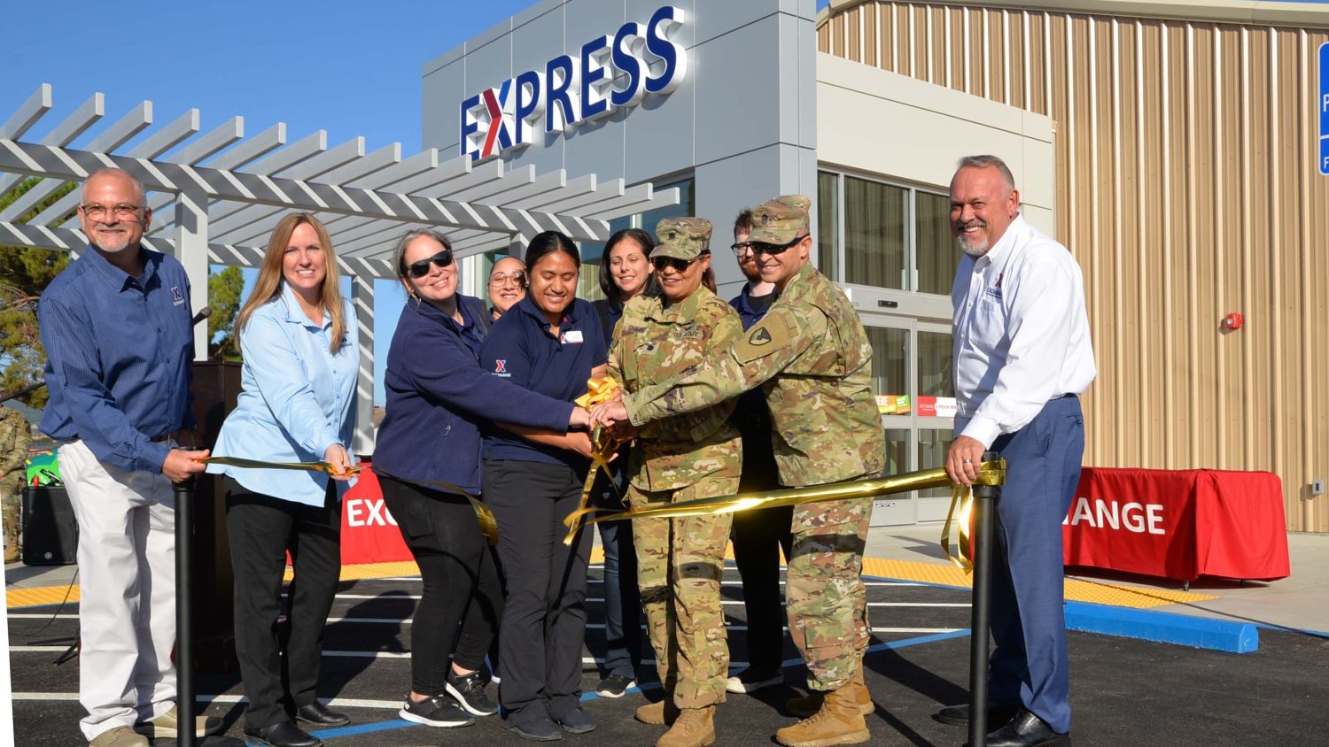 Left to right in ribbon cutting photo: Exchange West Coast Vice President Robert Rice, Travis BX General Manager Cathie Byrns, Supervisor Charlene Sanchez, Customer Experience Associate Wendy Lopez, Facility Manager Fa’ Tufono, Supervisor Kaysi Delgado, Garrison Commander Lt. Col. Marisol Chalas, Roving Store Worker Cameron Ellis, Garrison Command Sgt. Maj. Eric Soto, Exchange Western Region Senior Vice President Ronny Rexrode.