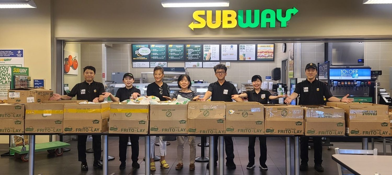 Subway managers on Camp Humphreys, Kim, Hyon-chun, Family Mini Mall, Cha-Hye-chin, Sentry Mini Mall, Heysun Banks, President of AUSA spouse, Katherine Yum, AUSA secretary, Chong, Son-ho, Zoeckler Mini Mall, Cho, Mi-ae, Family Mini Mall, Yi, Hui-chan, Troop Mini Mall, work together to fill an order for 800 six-inch subs with chips and water for 600 Boy Scouts who were evacuated from the 25th World Scout Jamboree near Busan due to the extreme heat wave. Since then, the Camp Humphreys restaurant team has provided more than 1,450 meals for the Scouts sponsored by AUSA. The jamboree expected more than 40,000 Scouts between the ages 14 to 17 from 150 countries to attend the 12 days event that kicked off on Aug. 1. This is the second time for Korea to host the event, the first jamboree was in 1991. (AAFES Photo by Hwang, Yun-suk)



