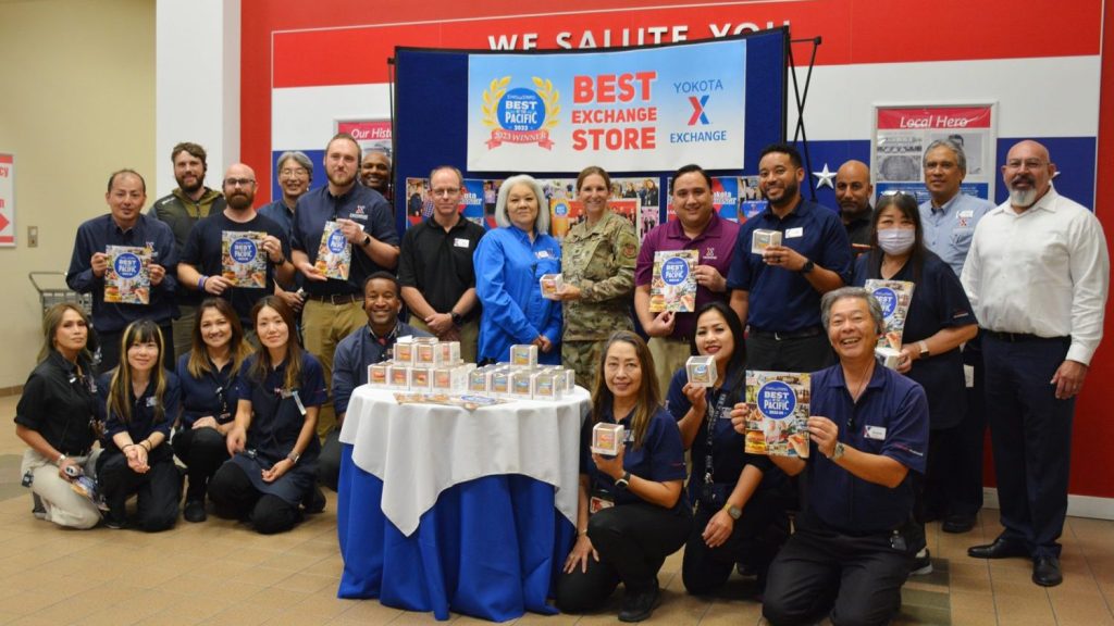 Air Force Lt. Col. Marci Hoffman, Stars and Stripes Pacific commander, poses for a picture with General Manager Andrew Defelice (purple shirt), Store Manager Evelyn Yamaguchi (light blue shirt) and Yokota Exchange associates after awarding their store as Mainland Japan’s “Best Exchange-Big Base”. For the past 19 years, Stars and Stripes polled members of military communities throughout the Pacific Theater on variety of subjects including: best American Forces Network Radio D.Js., best shopping facilities, best restaurants, and best phone services on and off base. This is the first time Yokota Exchange has won the award. (Courtesy Photo by Yokota Exchange)