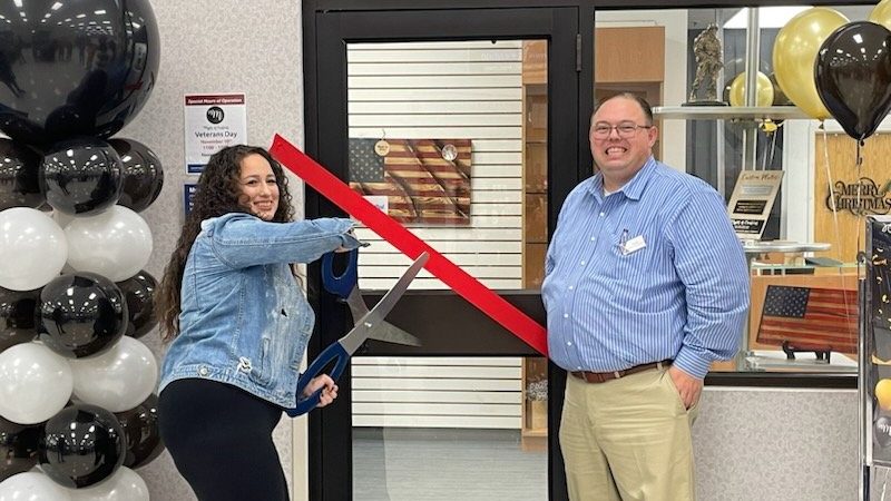 <b>Cutting the ribbon on Myles of Creation at Dyess AFB is co-owner Taryn Miles, accompanied by Dyess Exchange Services Business Technician William Smith Jr.</b>