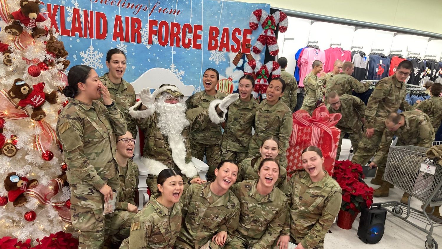 <b>Trainees sing carols (and sway along) while Santa conducts at the annual BMT Shopping Extravaganza at the Lackland AFB Exchange.</b>