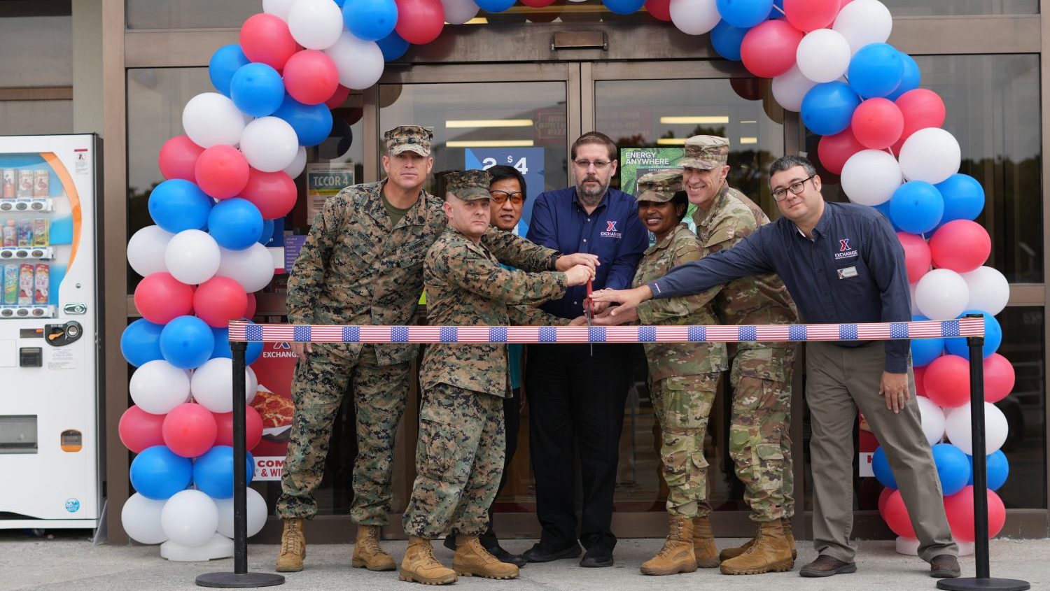 <b>(From Left to Right) On Dec. 1, Headquarters & Support Battalion and Marine Corps Installation Pacific- Marine Corps Base Butler’ Senior Enlisted Advisor Sgt. Maj. Timothy Anderson, Executive Officer Lt. Col. Spencer A. Szewczyk, Butler Express Manager Toru Kyan, Okinawa General Manager David Swenson, Exchange Pacific Region Army Sgt. Maj. Generose Green, Exchange Pacific Region Commander Air Force Col. Jason L. Beck and Okinawa Retail Business Manager Danny Cawood prepare to cut the ribbon during Camp Butler Express Upgrade 2.0 ceremony. The upgrades included the launch of Hunt Brothers Pizza, additional self-checkout registers and rearrangements to the interior giving the store a brand-new look. (U.S. Army Photo by Staff Sgt. Mark A. Kauffman)</b>