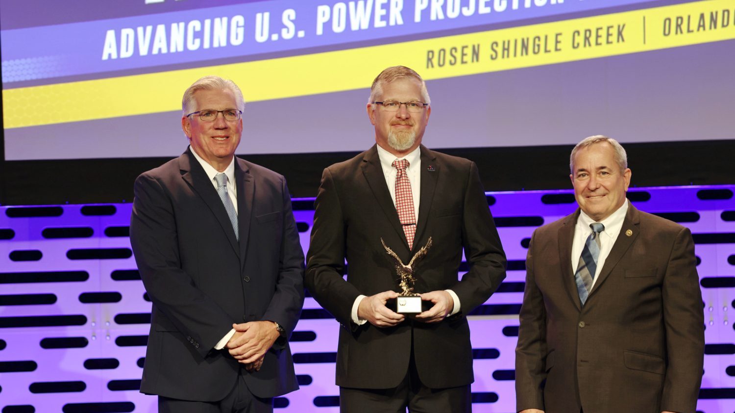 <b>Exchange Vice President of Contingency Plans Roger Neumann accepts his fourth award from the NDTA at the organization’s national meeting. From left: NDTA Chairman, FedEx Executive Vice President and Chief Financial Officer John Dietrich; Neumann; and NDTA President and CEO Vice Adm. William Brown, USN (Ret.)</b>