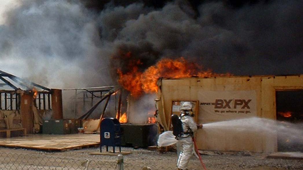 KANDAHAR, Afghanistan -- Air Force firefighters battle a blaze Feb. 21 that destroyed the exchange, barbershop, gift and coffee shop at Kandahar, Afghanistan. The blaze also destroyed the personal living quarters of 25 Army and Air Force Exchange Service employees. Damage costs are estimated at more than $1 million.  (U.S. Army photo by 1st Lt. Cory Angell)