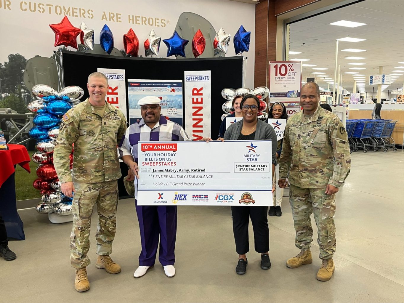 <b>From left: Fort Eisenhower Garrison Command Sgt. Maj. Aaron Rose, MILITARY STAR Your Holiday Bill Is on Us sweepstakes grand-prize winner retired Staff Sgt. James Mabry, Fort Eisenhower Exchange General Manager LaToya Harris, Fort Eisenhower Garrison Commander Col. Reggie Evans</b>