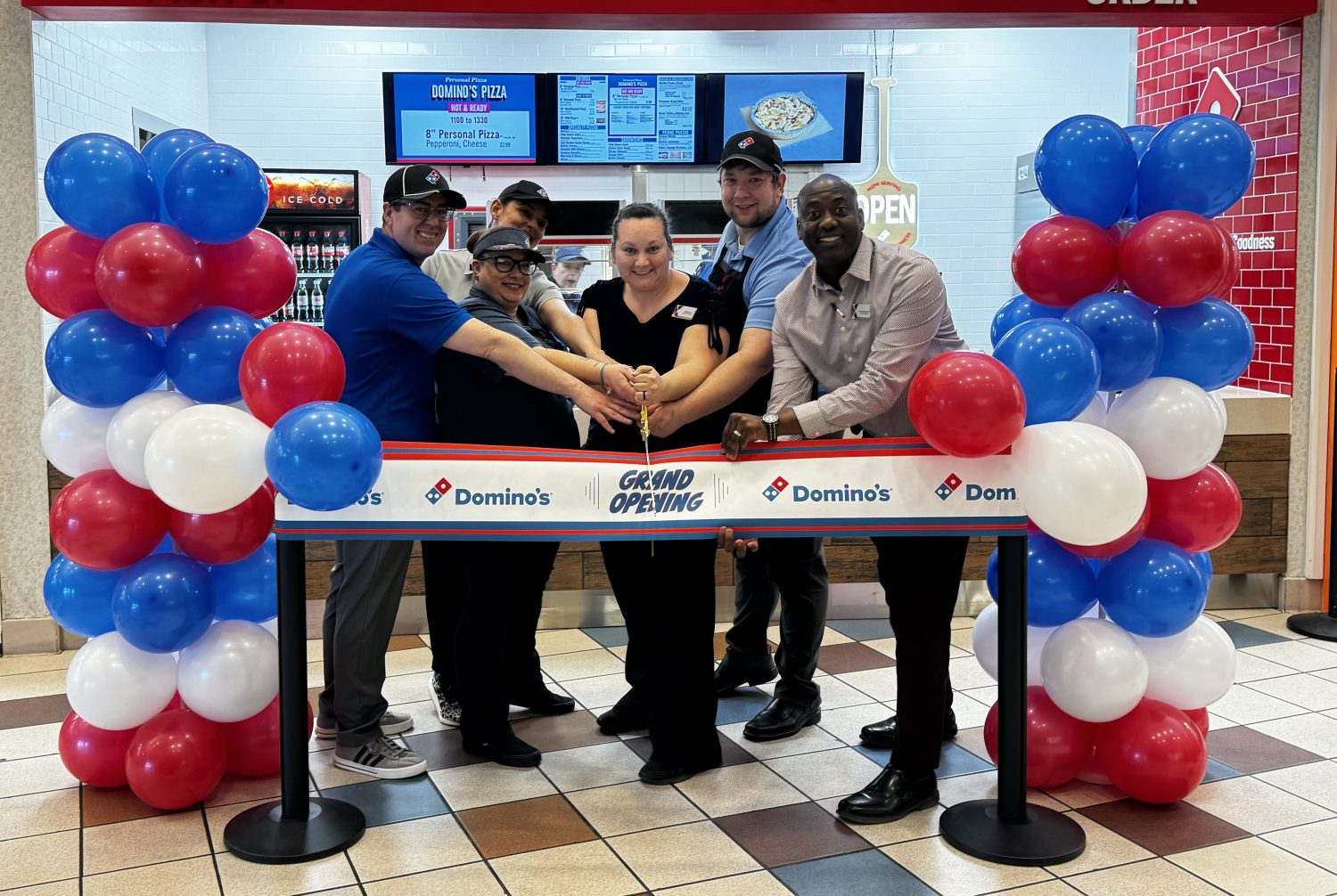 <b<Fort Riley Exchange welcomed its third Dominos location on the installation. From left: Co-owner Donald Cunningham and his wife Kailina; Store Manager Kailey Enger; Services Business Manager Jessica Tacy; General Manager Jermaine Wilson; and Co-owner Grant Classen. </b>