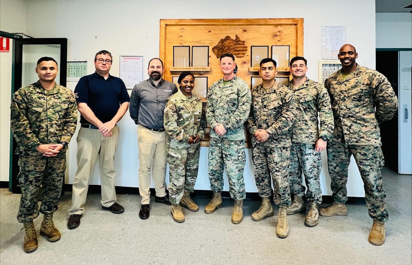 <b>Okinawa Retail Business Manager Danny Cawood, Pacific Region Retail Program Specialist Jonathan Brickey and Pacific Region Senior Enlisted Advisor Sgt. Maj. Generose Green with Marines at Robertson Barracks in Australia. Standing next to Green is Maj. Jack Free, the officer in charge of the "Wet" season detachment. In a joint venture that began in 2016, Marines operate the Exchange's Robertson Barracks stores, while the Exchange provides the merchandise.