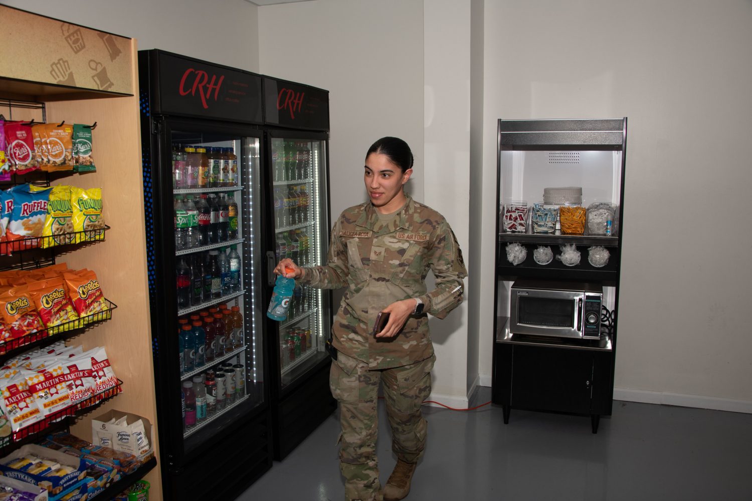 <b>.S. Air Force Senior Airman Kendra A. Alicea Rosa grabs a drink from the new 24/7 unattended retail unit at Joint Base Andrews, Md., April 25, 2024. The new unattended retail unit was opened to provide over 900 security forces personnel on base round-the-clock food options. (U.S. Air Force photo by Senior Airman Daekwon Stith)</b>