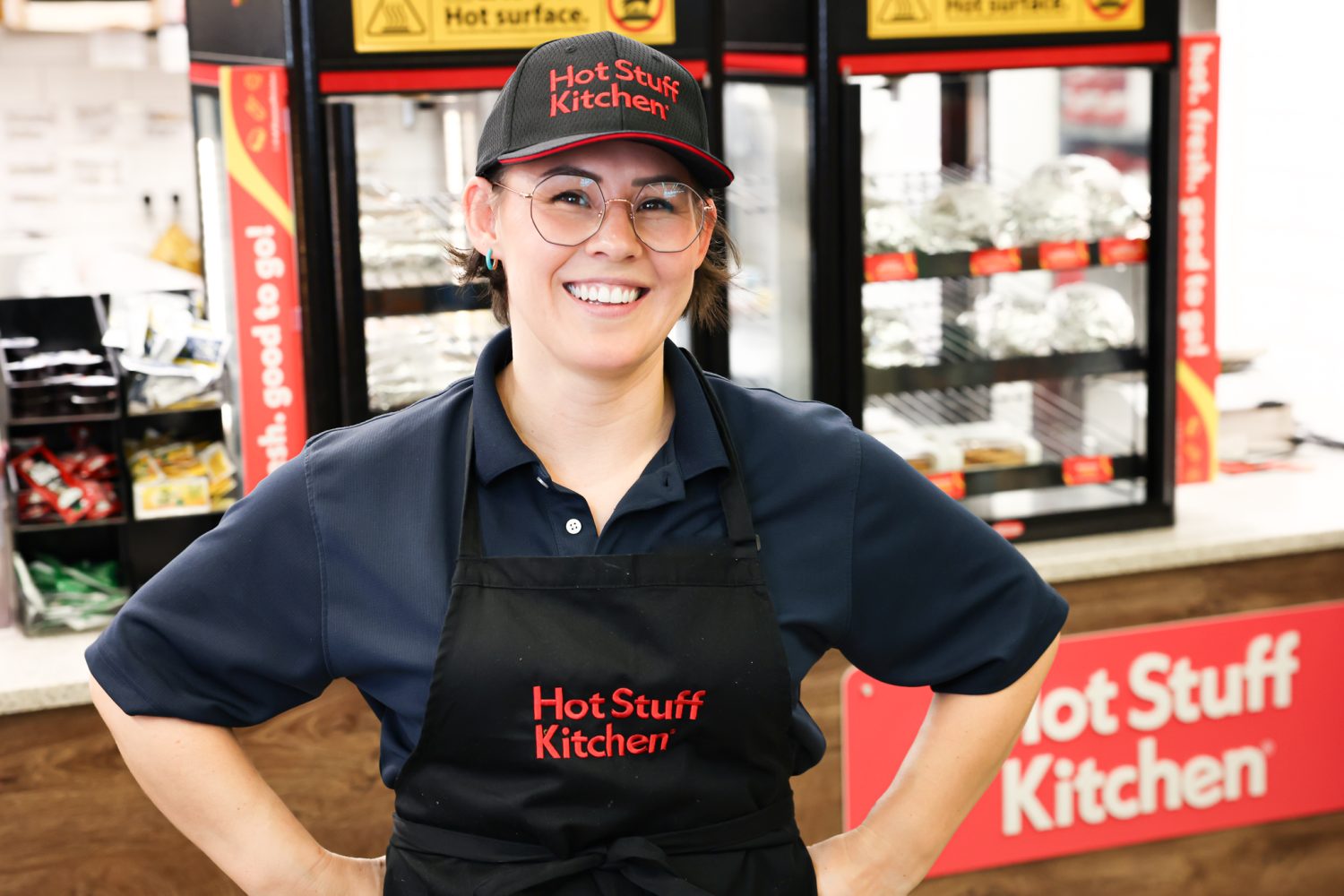 Pulaski Express store manager Ashlee Destajo in front of Hot Stuff Kitchen display.