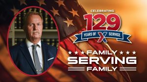 129 Years of Family Serving Family: Willy Rech standing in front of bookcase.