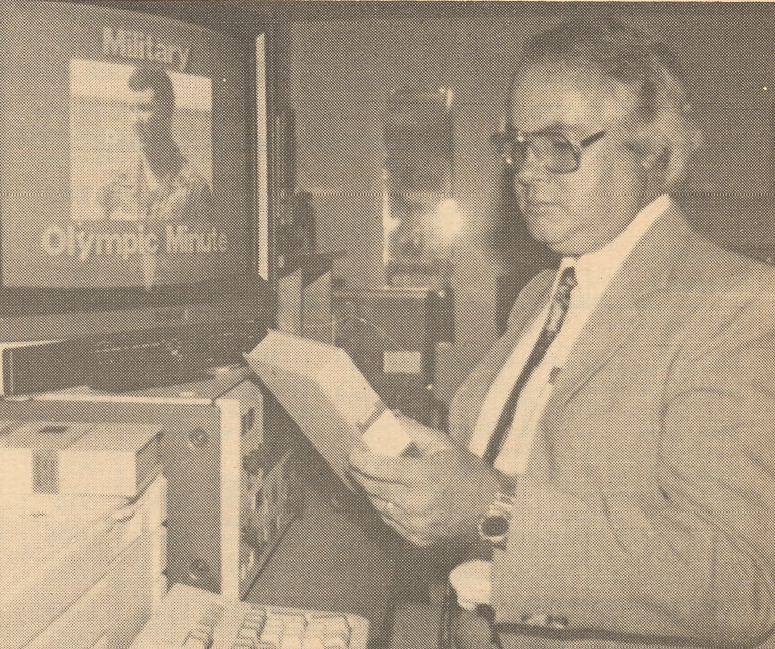 Tom Conway with Olympic Military Minute on monitor in background.