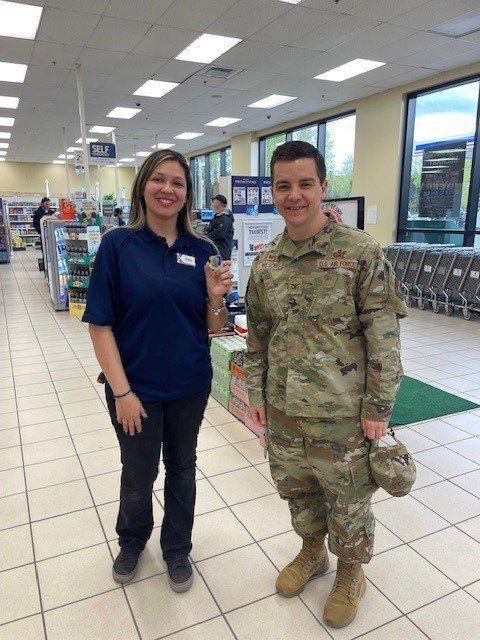 Kryzia Ceja with by 673rd Air Base Wing Commander Col. David Wilson.