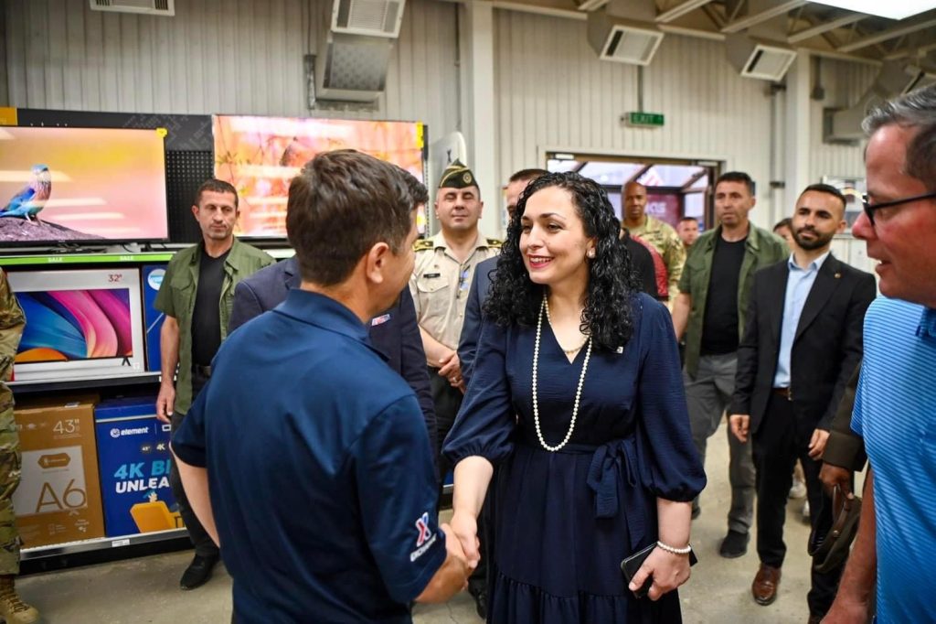 Camp Bondsteel Exchange associate Betim Hasani is greeted by Kosovo President Vjosa Osmani-Sadriu during the Camp Bondsteel Exchange's 25th-anniversary celebration.