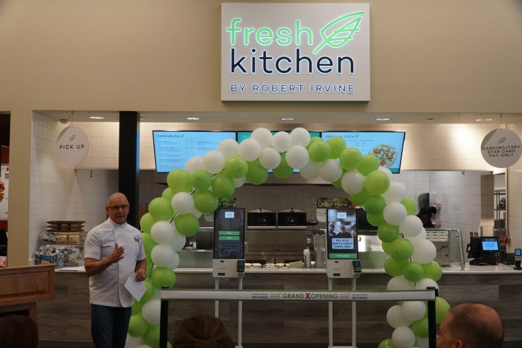 Photo of Robert Irvine in front of Fresh Kitchen by Robert Irvine at Joint Base Andrews Exchange.