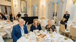 Exchange Director/CEO Tom Shull, Vice President of Marketing Customer Engagement Julie Mitchell and Senior Vice President of Brand Marketing Sandi Lute at a ballroom table at the 2024 Ragan PR Daily’s Content Marketing Awards at the Yale Club in New York City.