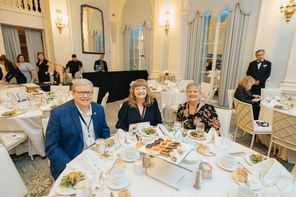 Exchange Director/CEO Tom Shull, Vice President of Marketing Customer Engagement Julie Mitchell and Senior Vice President of Brand Marketing Sandi Lute at a ballroom table at the 2024 Ragan PR Daily’s Content Marketing Awards at the Yale Club in New York City.