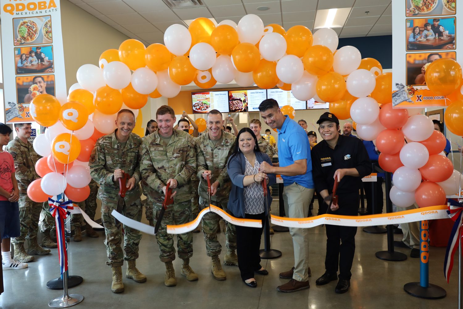 <b>Cutting the ribbon on the Qdoba at the Kadena AB Exchange are, from left: From Left to Right: Col. Lundeby, 18th Wing Deputy Commander; Airman Basic Jesse West; Col. Jason Beck, Exchange Pacific Region Commander; Kristine Cowley, Okinawa Exchange general manager; Luis “Lu” Story, Qdoba franchise business consultant and Alex Aspiras, Kadena Qdoba manager</b>