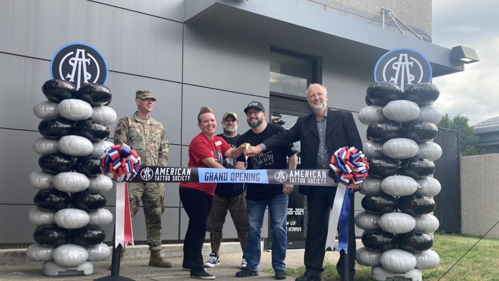 Wright-Patterson Air Force Base, Exchange and American Tattoo Society leaders cut the ribbon on the new American Tattoo Society shop.