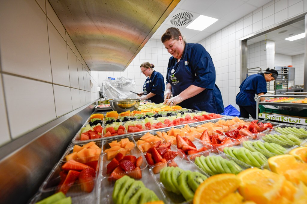 An Exchange school meal program associate at Vogelweh Elementary School prepares 500 fruit servings for the program.