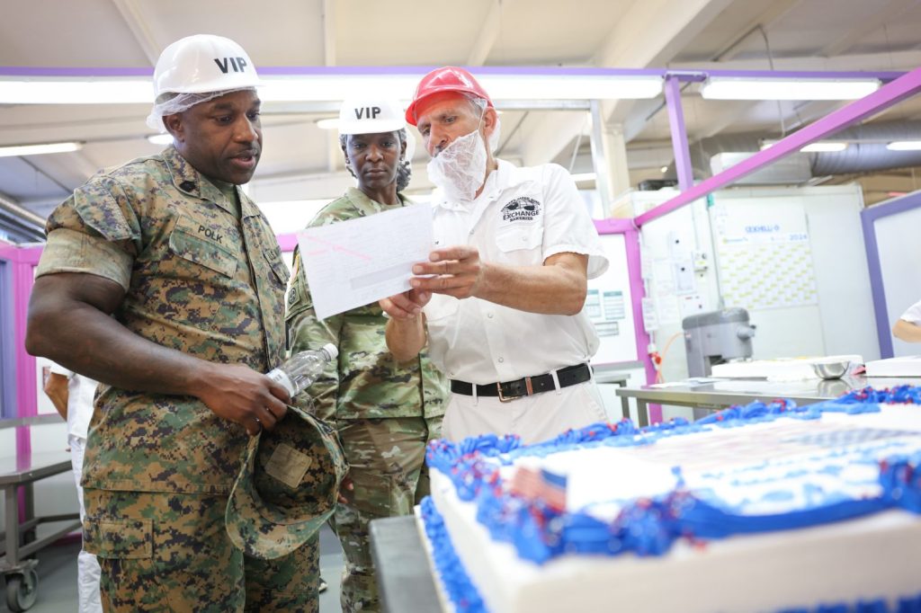 <b>Gruenstadt Bakery Manager Klaus Schlosser explains on of the bakery's processes to Defense Commissary Agency (DeCA) Senior Enlisted Advisor Master Gunnery Sgt. Anthony D. Polk , left, and Sgt. Maj. Ashley N. Ikegwuonu, the Exchange’s Europe/Africa/Southwest Asia Senior Enlisted Advisor.