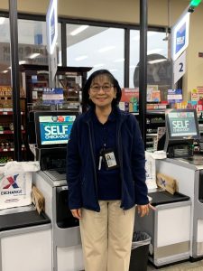 Photo of Jocelyn Pena at self-checkout stations.